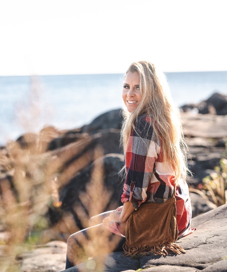 Porträtt av Lisa Miskovsky på en klippa vid havet